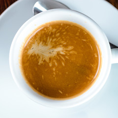 cup of fresh espresso on table, view from above