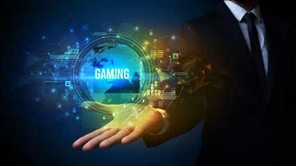 Elegant hand holding GAMING inscription, digital technology concept