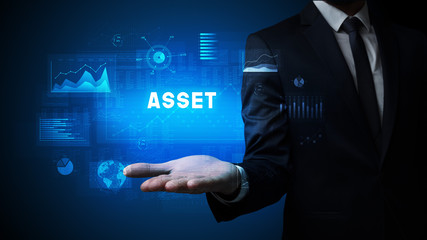 Hand of Businessman holding ASSET inscription, business success concept