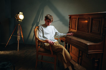 man sitting on chair in hotel room