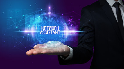 Man hand holding NETWORK ASSISTANT inscription, technology concept