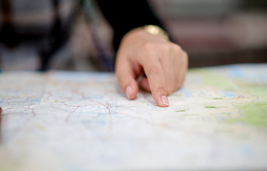 Hand and map of tourists trekking for accuracy.