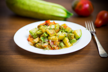 fried zucchini with red pepper, onions, tomatoes and other vegetables