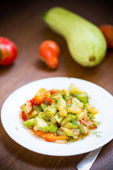 fried zucchini with red pepper, onions, tomatoes and other vegetables