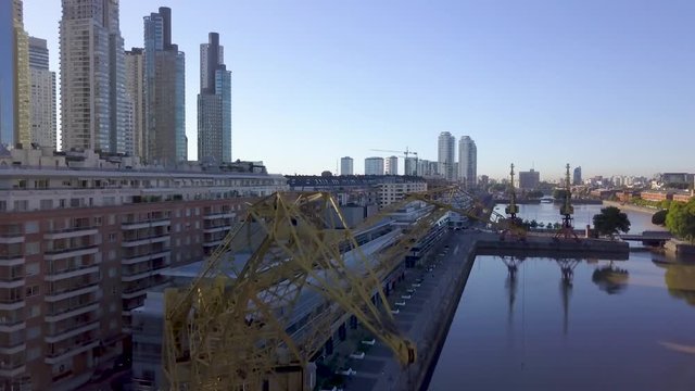 Aerial parallax of loading cranes in Puerto Madero, revealing Buenos Aires skyline