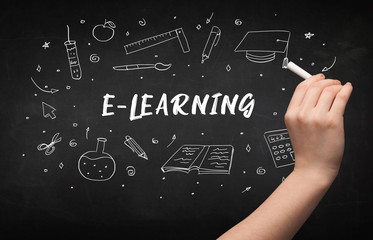 Hand drawing E-LEARNING inscription with white chalk on blackboard, education concept