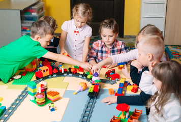 Educational toys for preschool and kindergarten child. Child playing with constructor blocks at class.