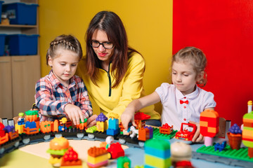 Educational toys for preschool and kindergarten child. Child playing with constructor blocks at class.