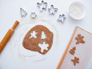 Homemade bakery making, gingerbread cookies in form of Christmas tree, gingerbread man. New year treat for Santa Claus cooking. Homemade bakery, xmas sweet, winter holidays concept. Christmas baking