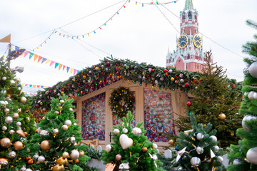 Kremlin clock tower, fir trees with lights and balloons outdoors, Moscow, winter, Christmas market, red square,