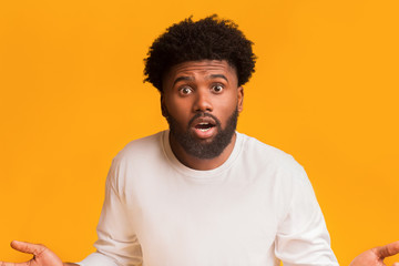Surprised bearded black man standing with open mouth