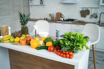 Healthy food, fruit, vegetable, berries , leaf vegetable on a table in a kitchen background. Organic food concept.