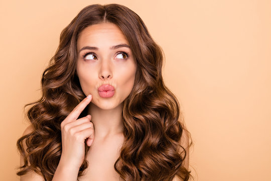 Close-up portrait of her she nice-looking attractive lovely gorgeous well-groomed pensive wavy-haired girl thinking looking aside pouted lips isolated over beige pastel color background