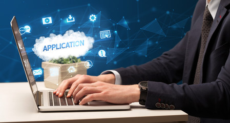 Businessman working on laptop with APPLICATION inscription, modern technology concept