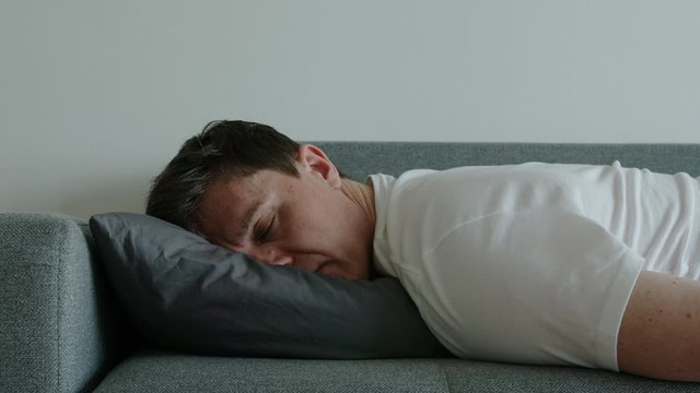 DEPRESSION: Portrait of young man sleep and turn over on a pillow