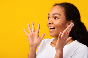 Amazed african american girl looking at free space