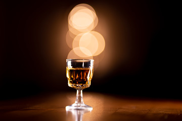 Glass of Bourbon Whiskey on a Wooden Table