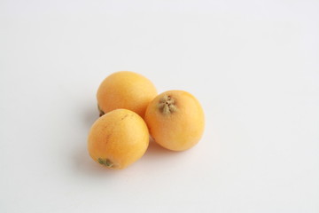 delicious yellow medlar fruit with white background