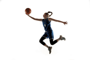 Young caucasian female basketball player of team in action, motion in jump isolated on white background. Concept of sport, movement, energy and dynamic, healthy lifestyle. Training, practicing.