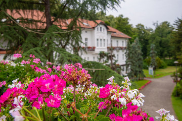 Banja Koviljaca, Serbia - July 13, 2019: Beautiful landscape with trees and flowers and architecture in formal park, garden in medical wellness center Banja Koviljaca