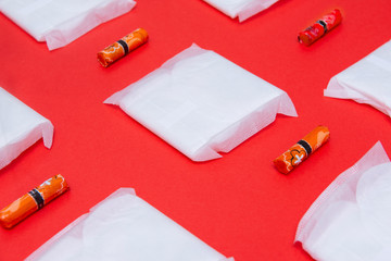 white sanitary pads, tampons on red background