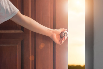 Women hand open door knob or opening the door,grand opening,Close up hand open door. - Powered by Adobe