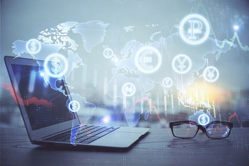 Stock market graph on background with desk and personal computer. Multi exposure. Concept of financial analysis.