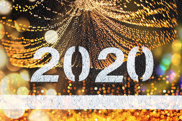 Background for 2020 new year calendar, white letters on black asphalt and party lights.