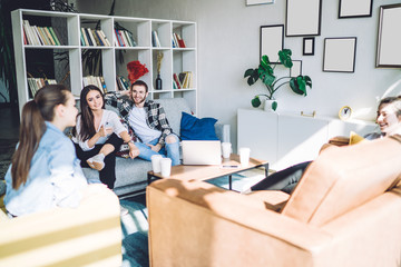 Young content people catching up with each others news at home