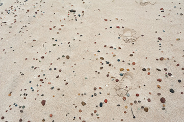 Footprints on the stony beach. Baltic sea, Poland.