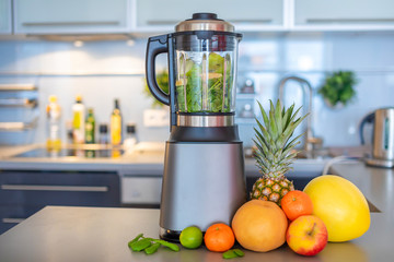 Making green smoothies with blender in home kitchen, healthy eating lifestyle concept