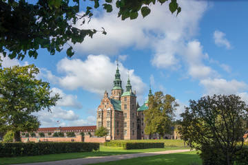 Fototapeta na wymiar Park View Historic Rosenborg Castle under Blue Skies in Copenhagen