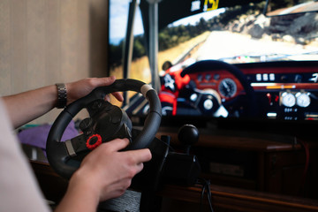 man learns how to drive the car on the virtual  driving auto simulator