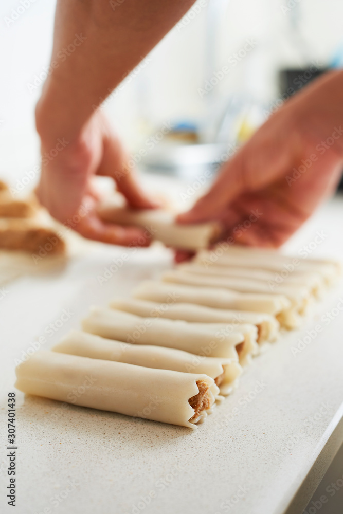 Canvas Prints man preparing meat stuffed cannelloni.