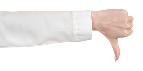 Female caucasian hands in a white office blouse, shirt isolated white background showing  gesture thumb down, disapproval.  woman hands in business office style showing different gestures