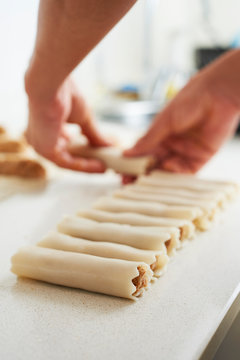 man preparing meat stuffed cannelloni.