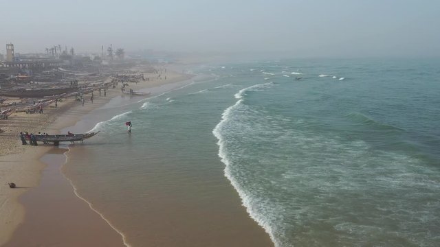Aerial view of fishing village, pirogues fishing boats in Kayar, Senegal. Photo made by drone from above. Africa Landscapes.