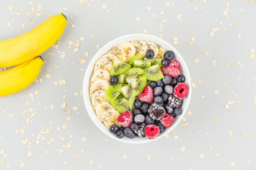 Healthy breakfast smoothie bowl topped with raspberries, blueberries, kiwi, bananas, BlackBerry and seeds chia. Vegan food. 
