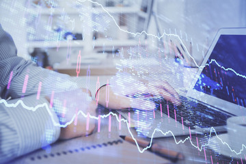 Multi exposure of stock market chart with man working on computer on background. Concept of financial analysis.