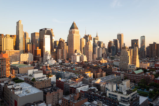 Fototapeta Sunset panorama of Manhattan's Hell's Kitchen skyline as seen from the 10th Avenue, Midtown Manhattan, New York City. Taken on September the 25th, 2019.