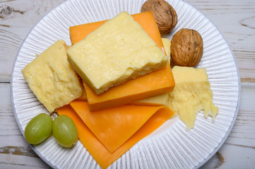 Cheese collection, blocks and slices of yellow and matured english cheddar cheese