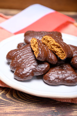 Tasty gingerbread glazed cookies from Torun, Poland and flag of Poland