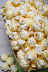 Green paper box with sweet popcorn ready to eat