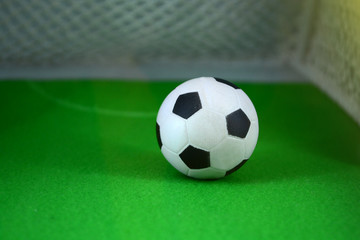 Soccer ball on green soccer field the gate