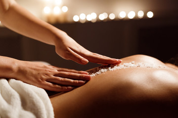 Spa concept. Woman receiving salt back massage