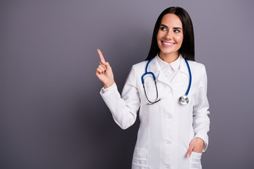 Portrait of her she nice attractive lovely charming cheerful friendly brunet girl showing copy space professional medical help aid visit doc isolated on grey pastel color background