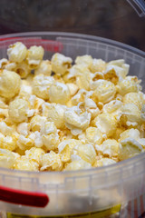 Plastic bucket with sweet popcorn ready to eat