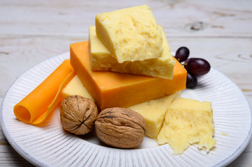 Cheese collection, blocks and slices of yellow and matured english cheddar cheese
