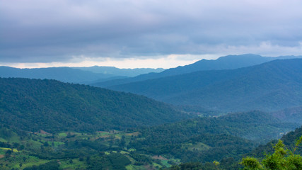 Valley in Na Haeo District with mountains and cloud sky in the background, Loei, Thailand.