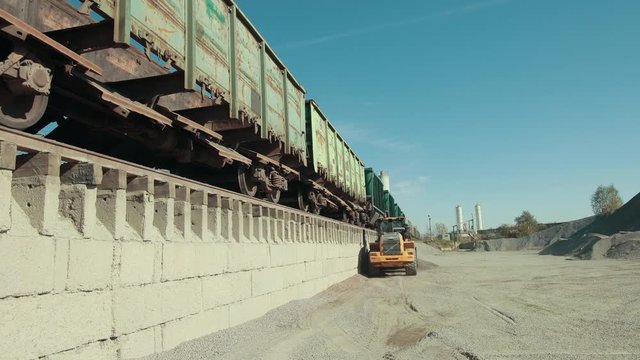 The tractor in yellow is waiting for the product to be released completely. The job is there for it and it will perform it well as ts capable of it.